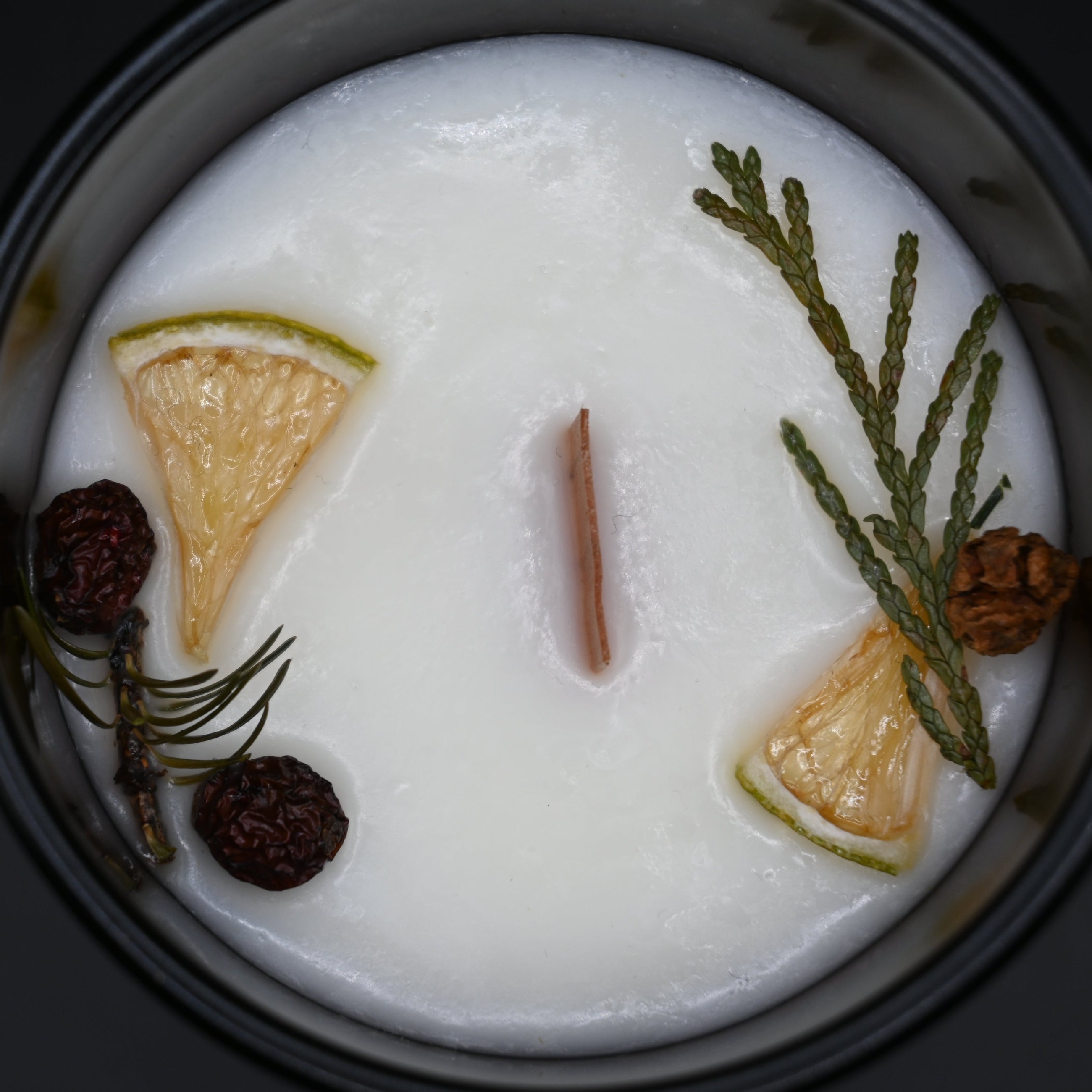Candle with decorative elements on a dark background