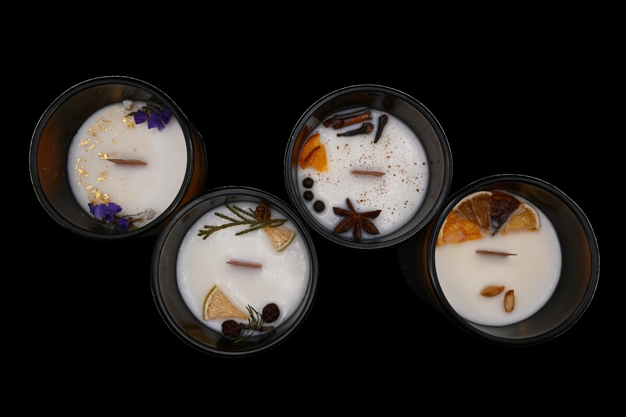 Spirituum luxury candle collection: four handcrafted Swiss candles seen from above with natural ingredients